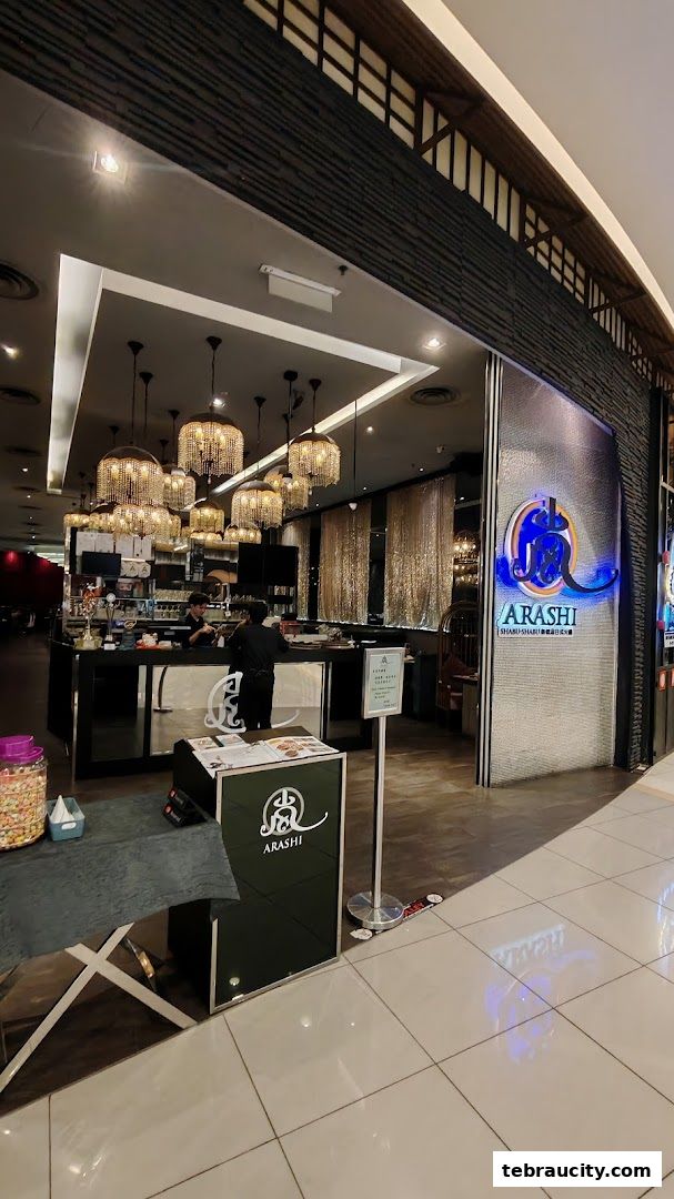 The entrance of Arashi Shabu-Shabu restaurant with elegant chandeliers and a prominent logo.