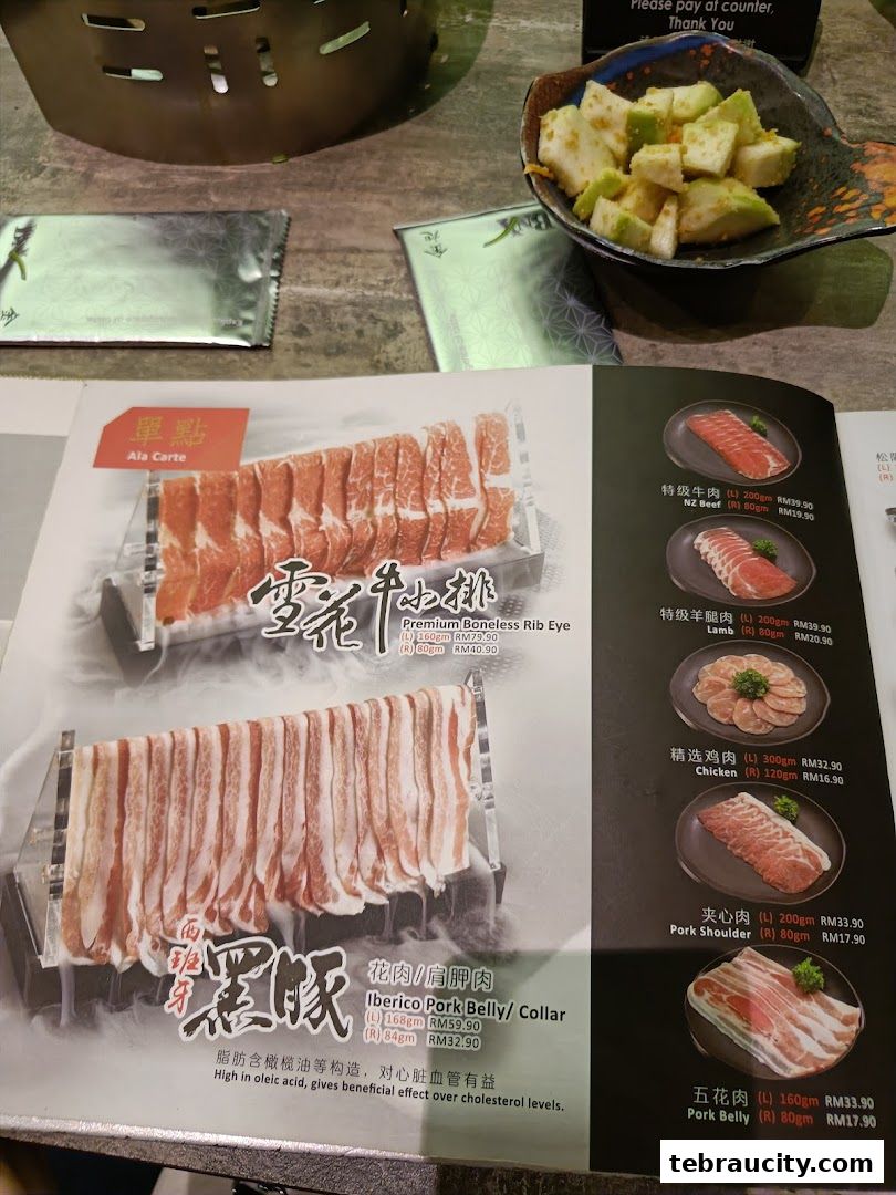 A menu showcasing various cuts of meat for shabu-shabu, including beef, lamb, chicken, and pork.