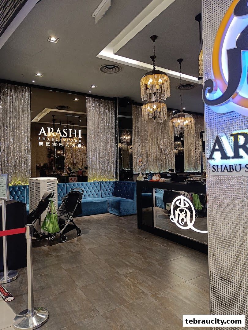 The entrance of Arashi Shabu-Shabu with plush seating and elegant chandeliers.