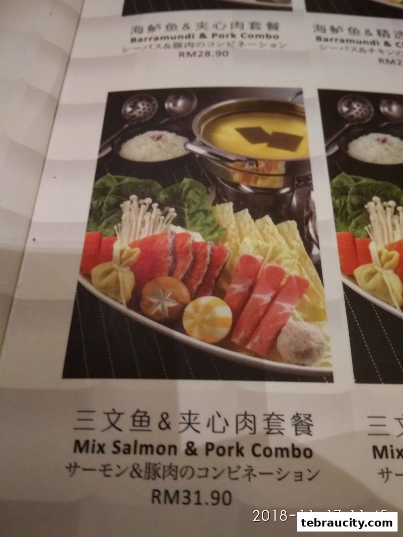 A close-up of a shabu-shabu menu featuring salmon and pork combo.