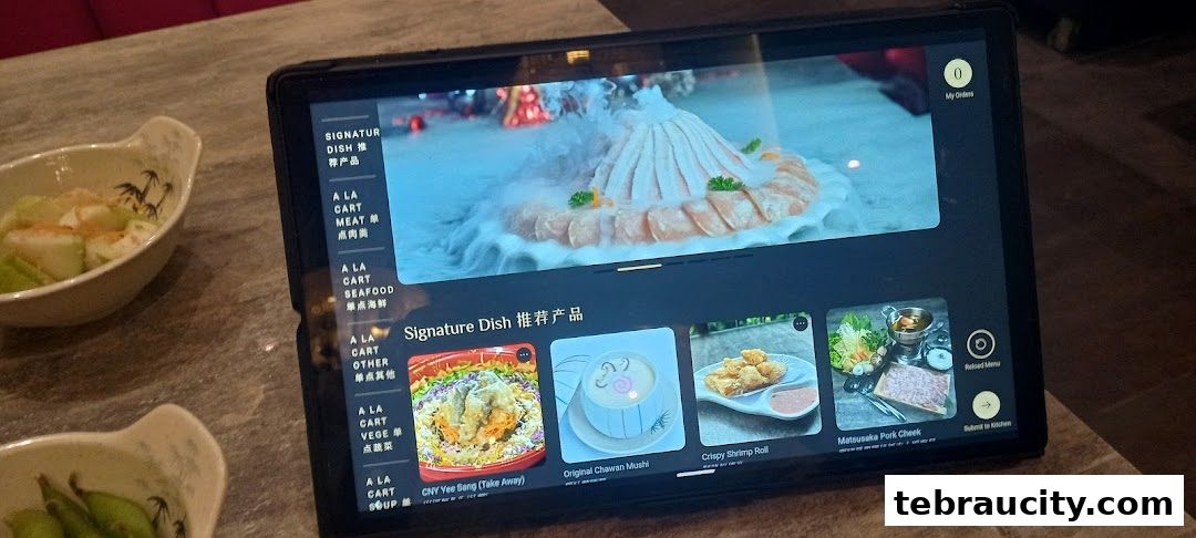 A tablet displays a digital menu for Arashi Shabu-Shabu, showcasing signature dishes and menu categories.