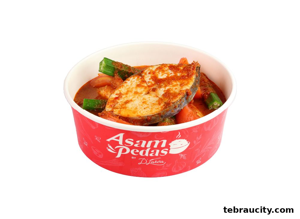 A bowl of Asam Pedas fish with okra and tomatoes, branded by D Laksa.
