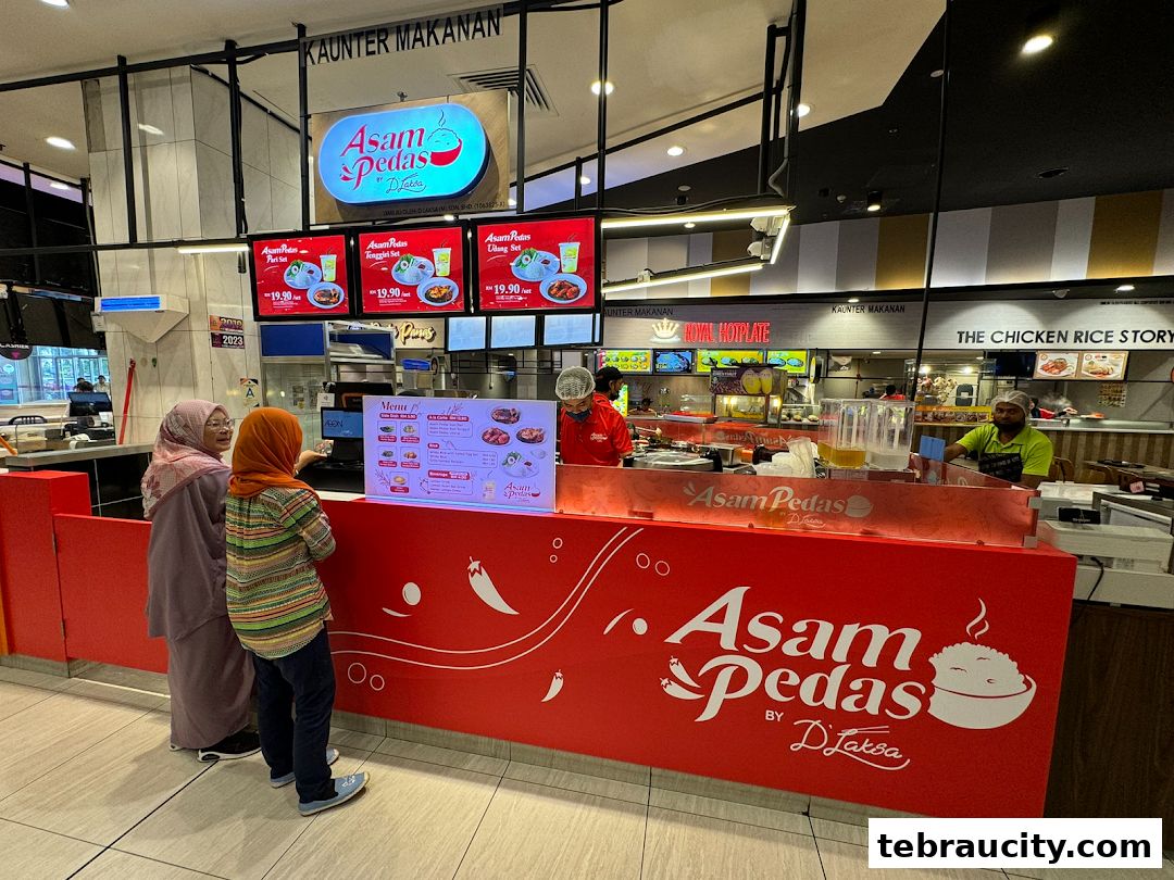 A food stall counter with a red facade displaying the shop's logo and menu items.