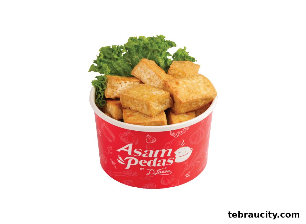 A red bucket filled with fried tofu pieces and garnished with lettuce.