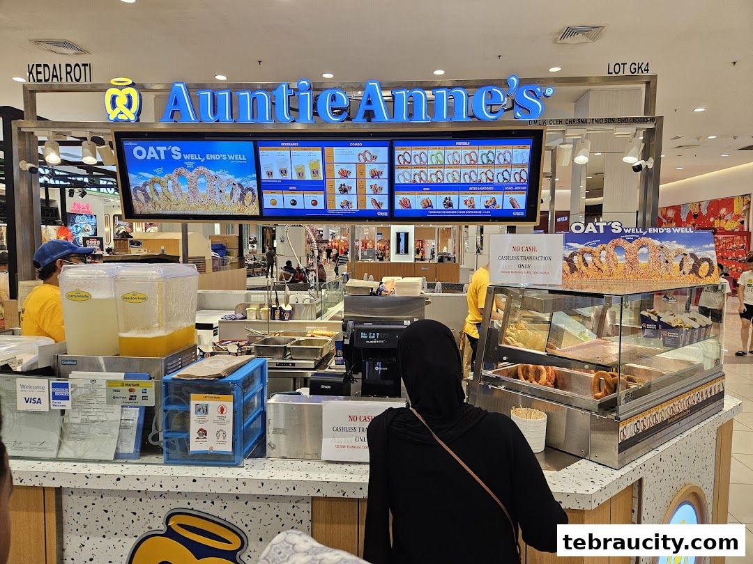 Auntie Anne's pretzel shop counter with a display of pretzels and drinks.