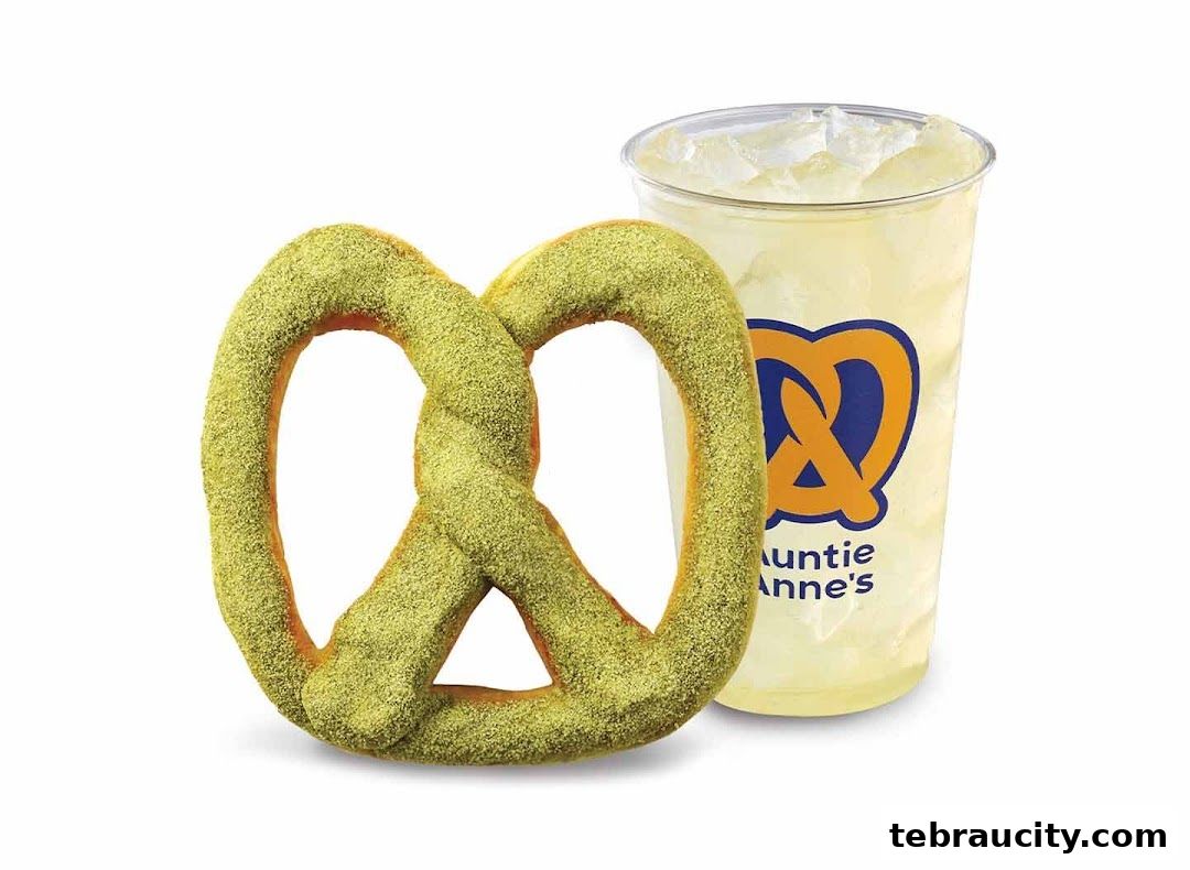 A green-dusted pretzel and a lemonade drink with the Auntie Anne's logo.