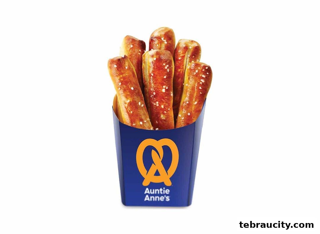 A container of Auntie Anne's pretzel sticks sprinkled with salt.