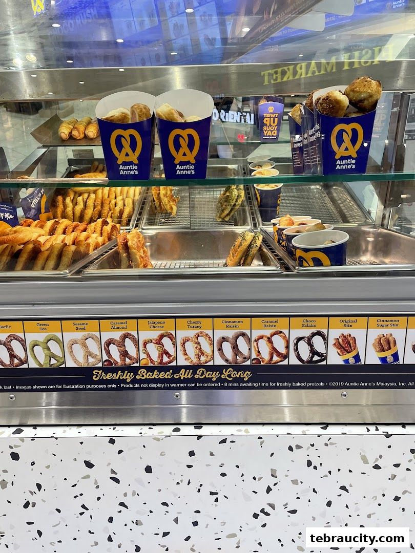 A display case filled with various freshly baked pretzels and pretzel bites from Auntie Anne's.