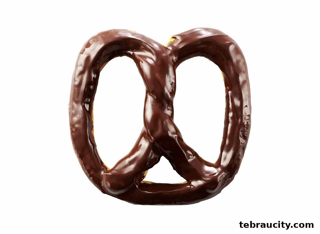 A close-up shot of a chocolate-covered pretzel on a white background.