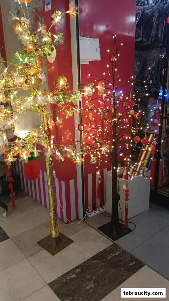 Two decorative trees with lights and ornaments, likely for festive occasions.