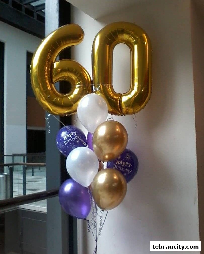 A bouquet of balloons, including large gold number balloons for '60' and smaller balloons.
