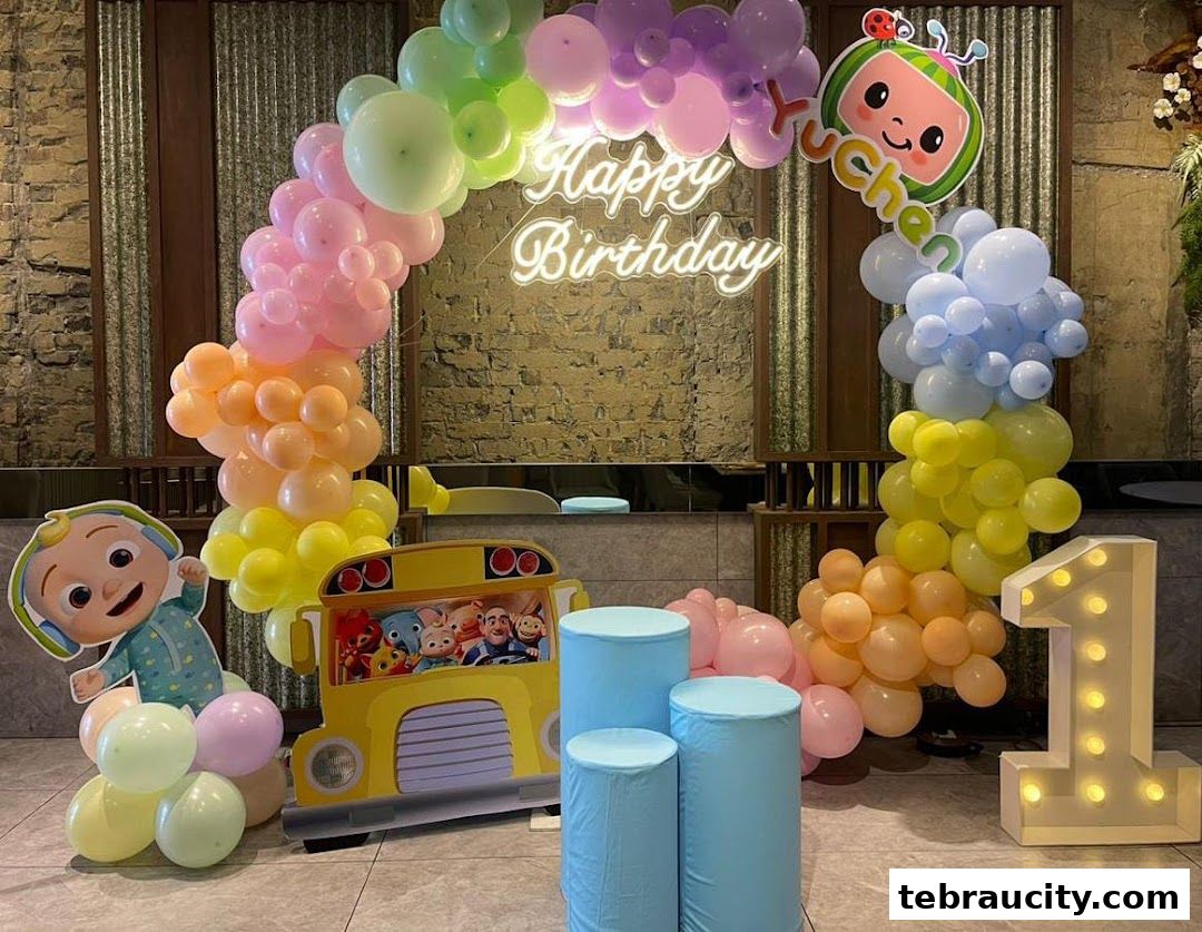 A vibrant balloon display for a child's birthday party with a CoComelon theme.