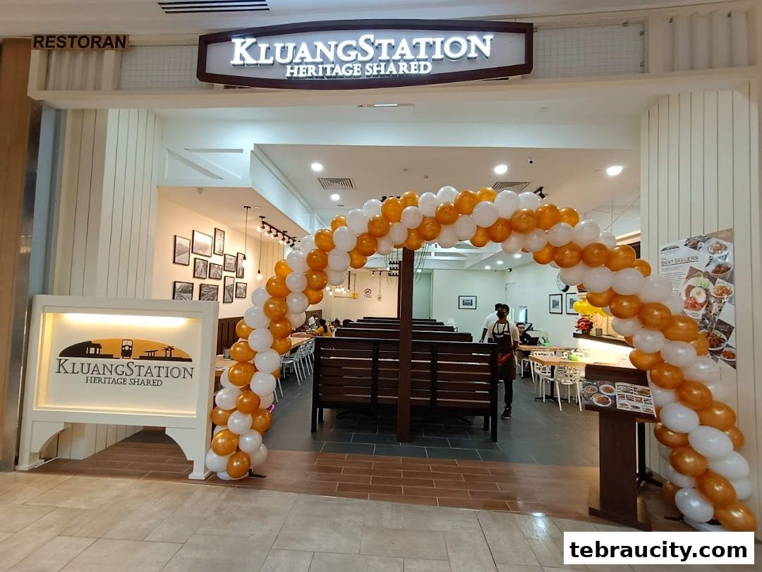 The entrance of KluangStation restaurant decorated with orange and white balloons.