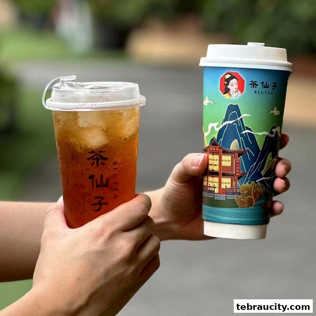 Two hands holding refreshing iced tea drinks from Beutea Aeon Tebrau.