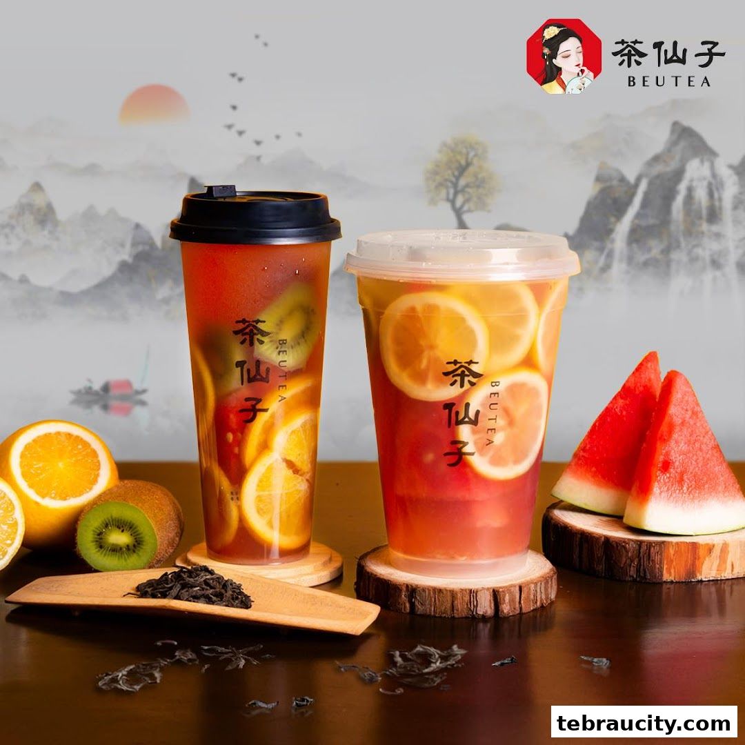 Two refreshing fruit teas with kiwi, orange, and lemon, served with watermelon slices.