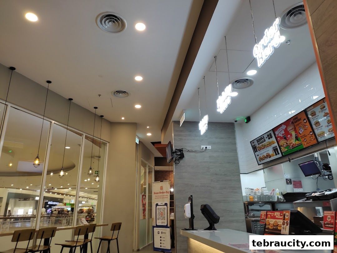 Interior view of a Burger King restaurant with seating, counter, and menu boards visible.