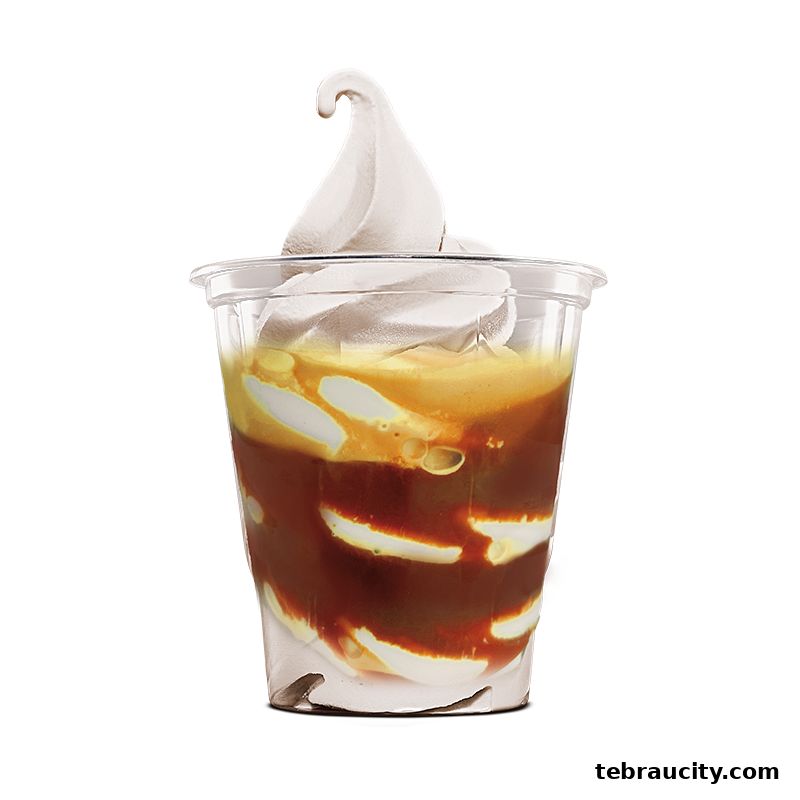 A close-up of a creamy soft-serve ice cream sundae with caramel sauce.