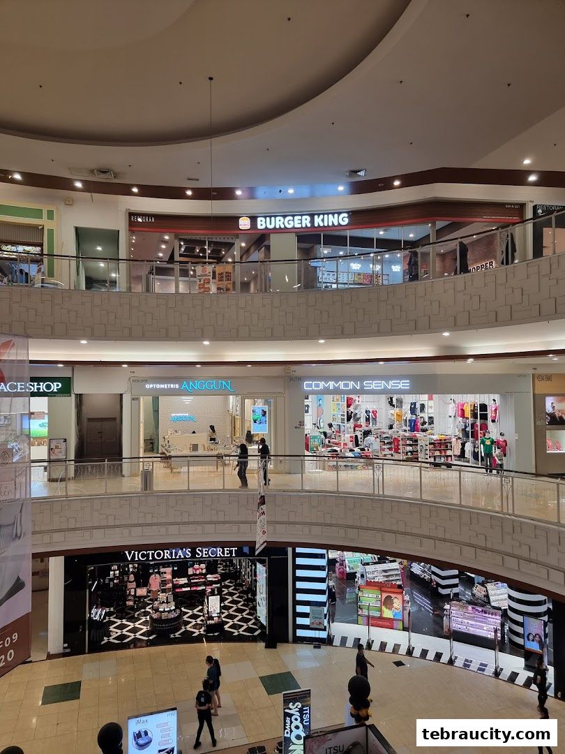 A view of the Burger King restaurant and other shops on multiple levels of a shopping mall.