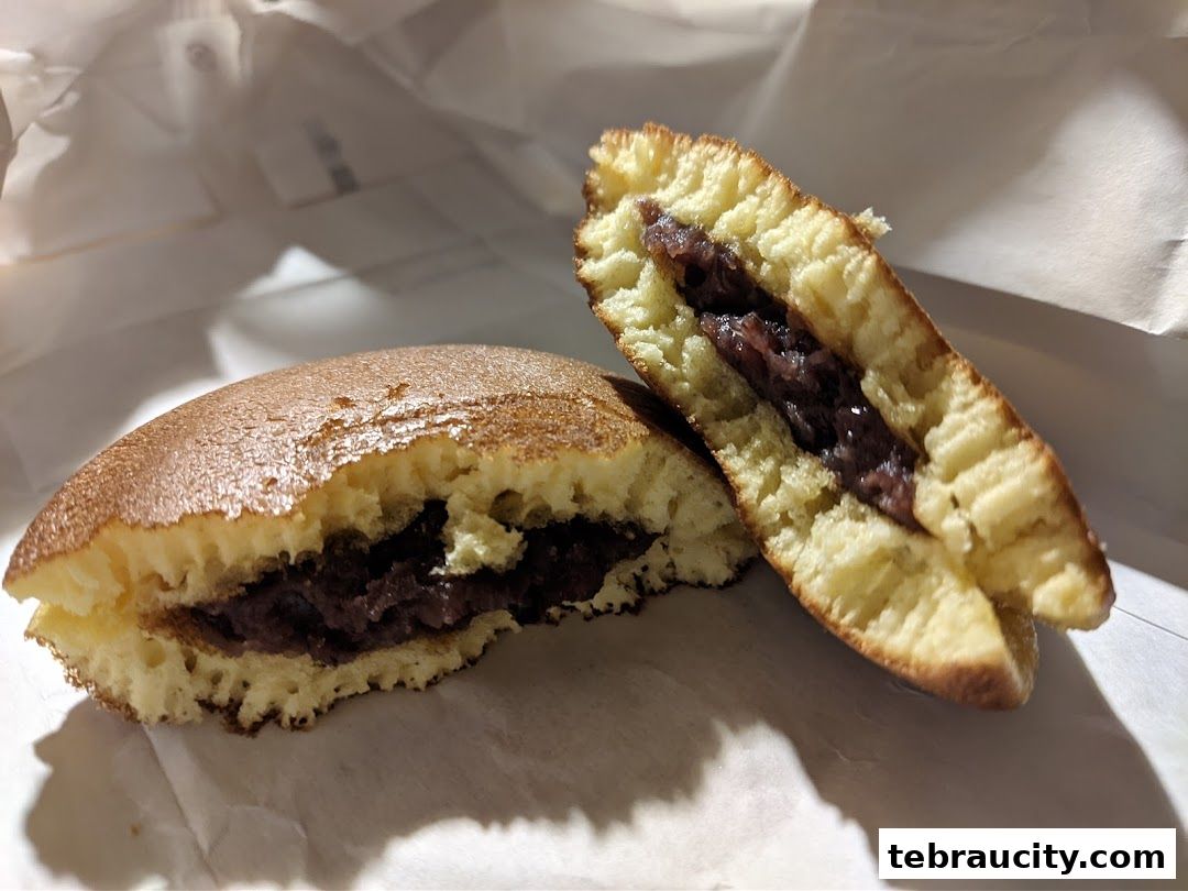 A close-up of a dorayaki, a Japanese pancake sandwich with red bean paste filling.