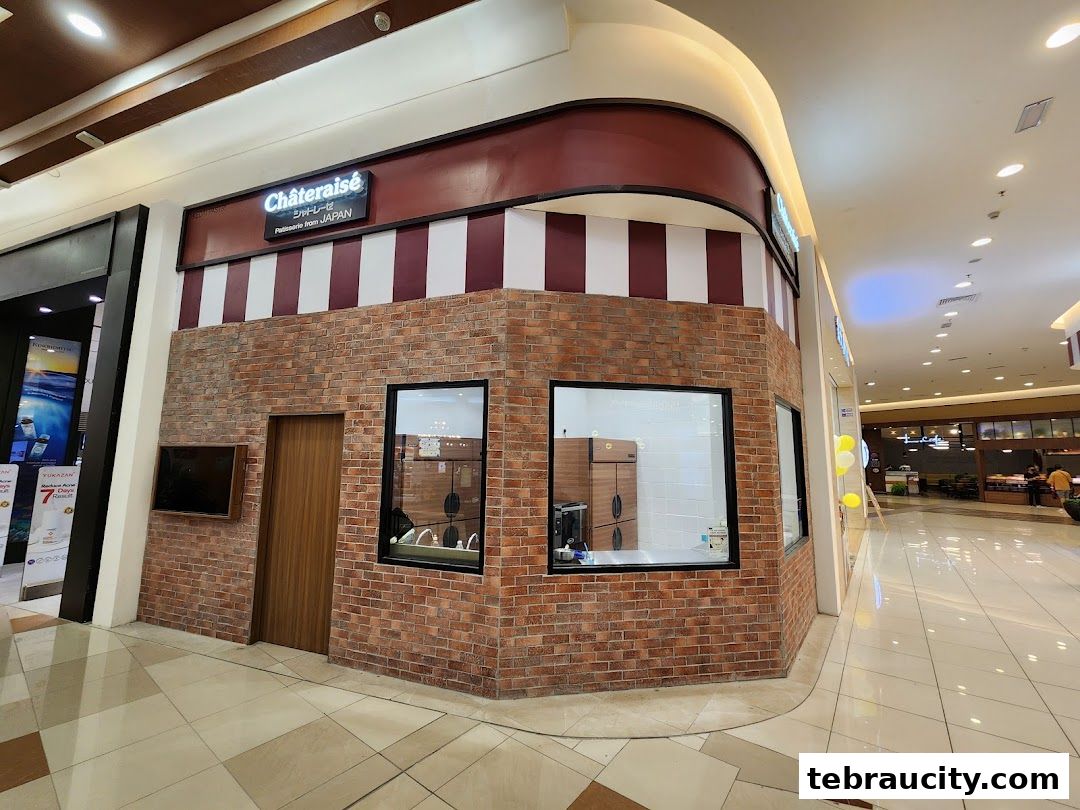 The Châteraisé shop front with brick facade and striped awning in a mall.