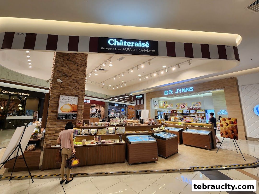 Châteraisé patisserie shop with display cases and a customer browsing products.