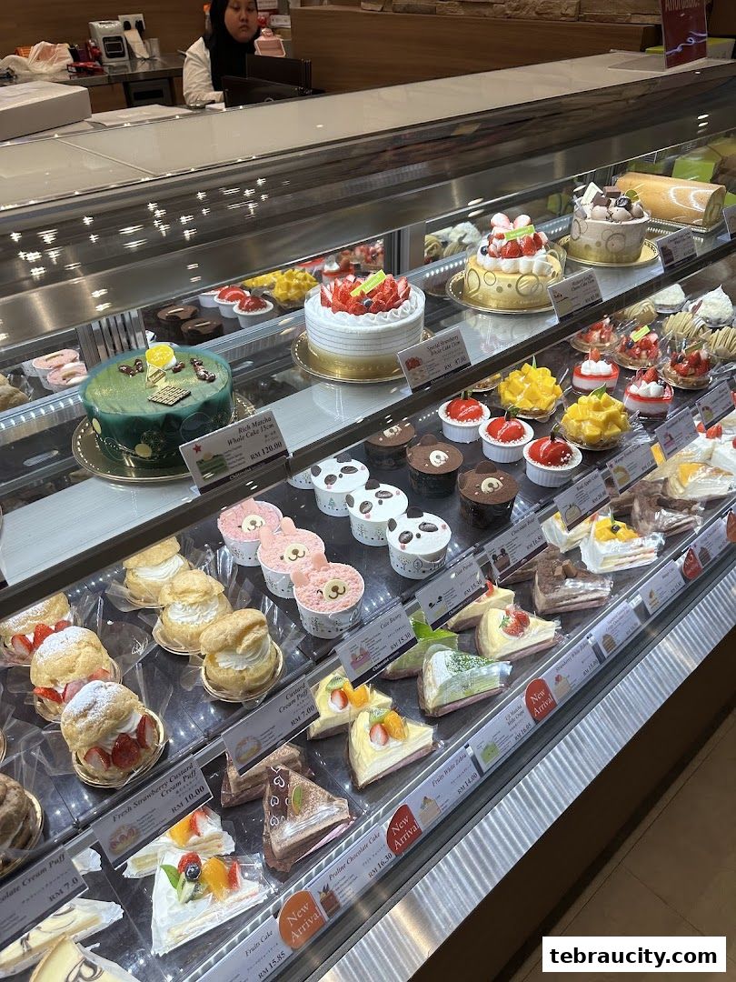 A display case filled with a variety of beautifully decorated cakes and pastries.
