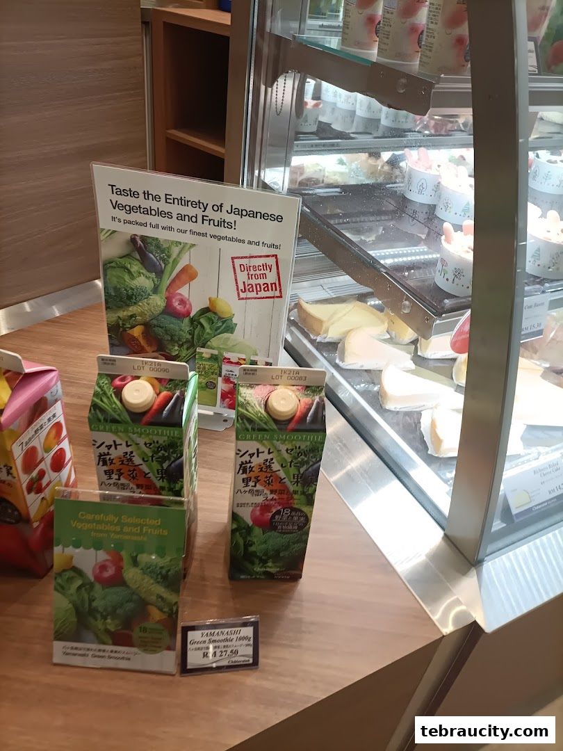 A display of Japanese vegetable and fruit products, including juices and a sign promoting fresh produce.
