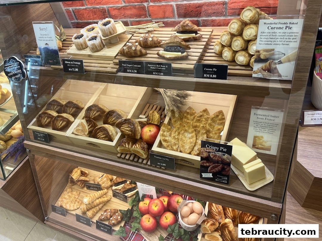 A display case filled with various pastries, including croissants, pies, and tarts, at Châteraisé.