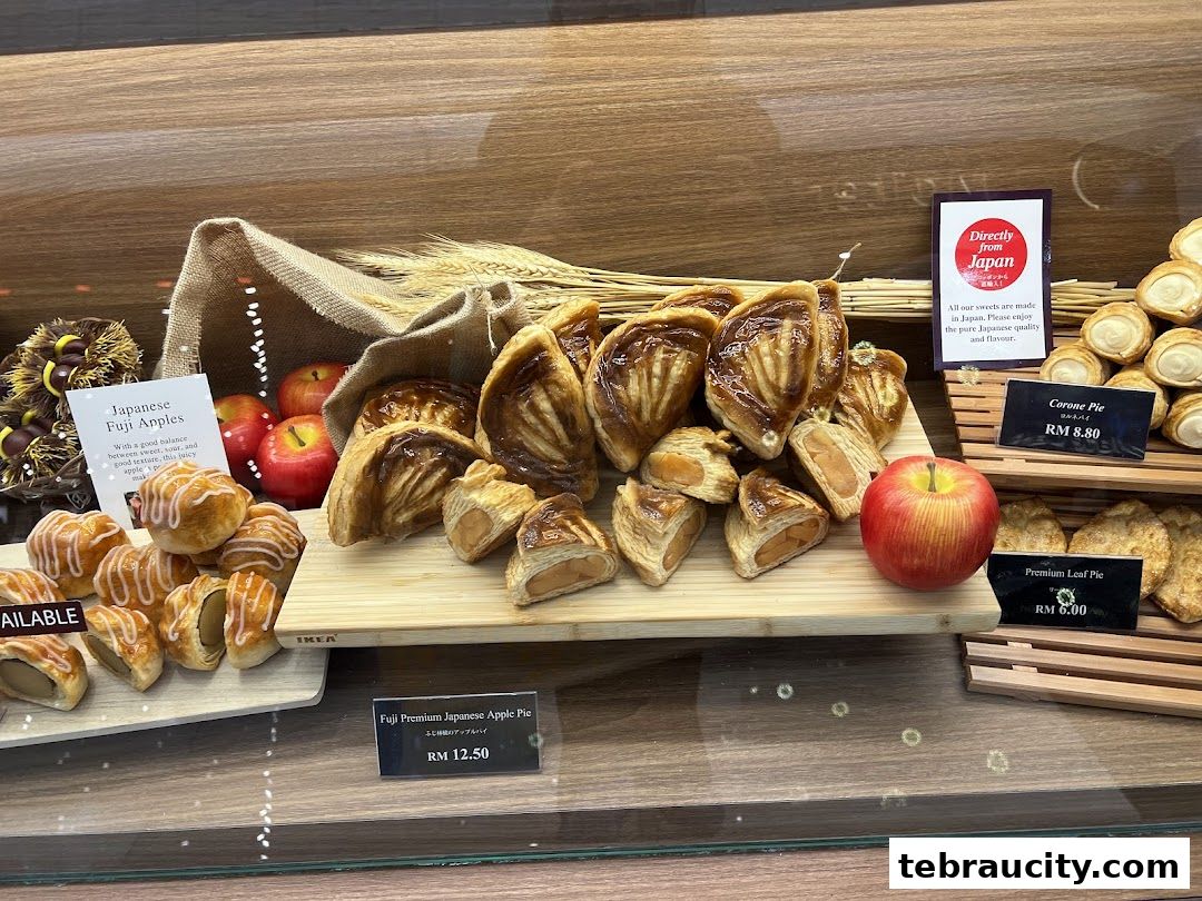 A display of freshly baked apple pies and pastries, with a sign highlighting Japanese origin.