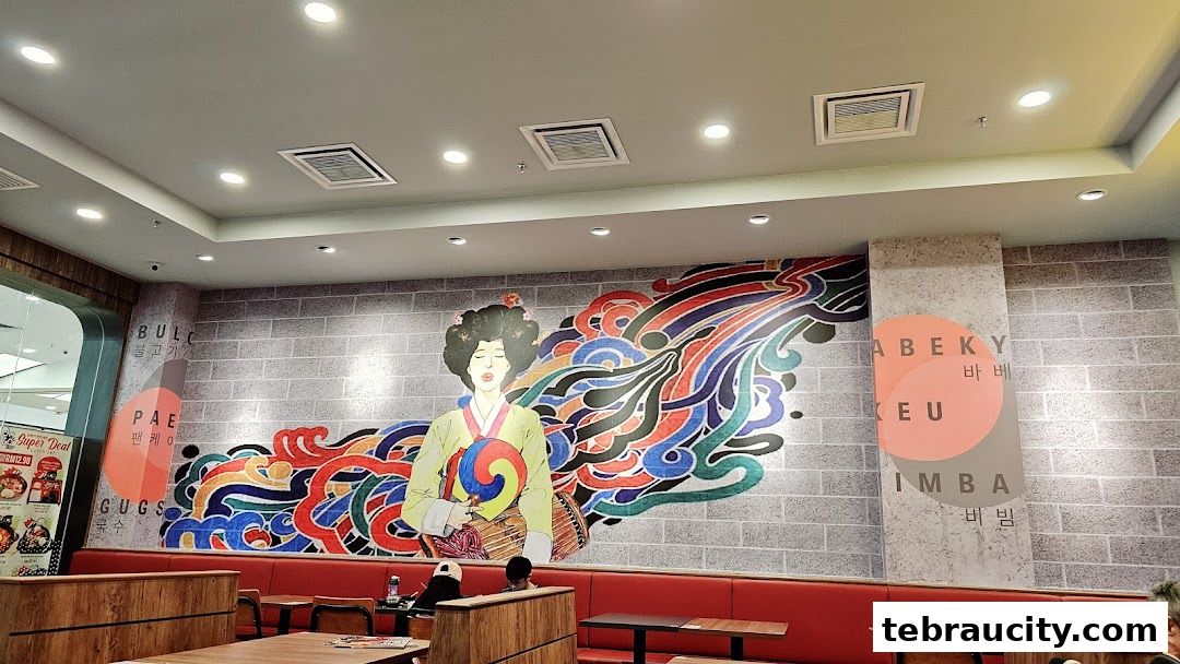 Interior of a Korean BBQ restaurant with vibrant wall art and seating.