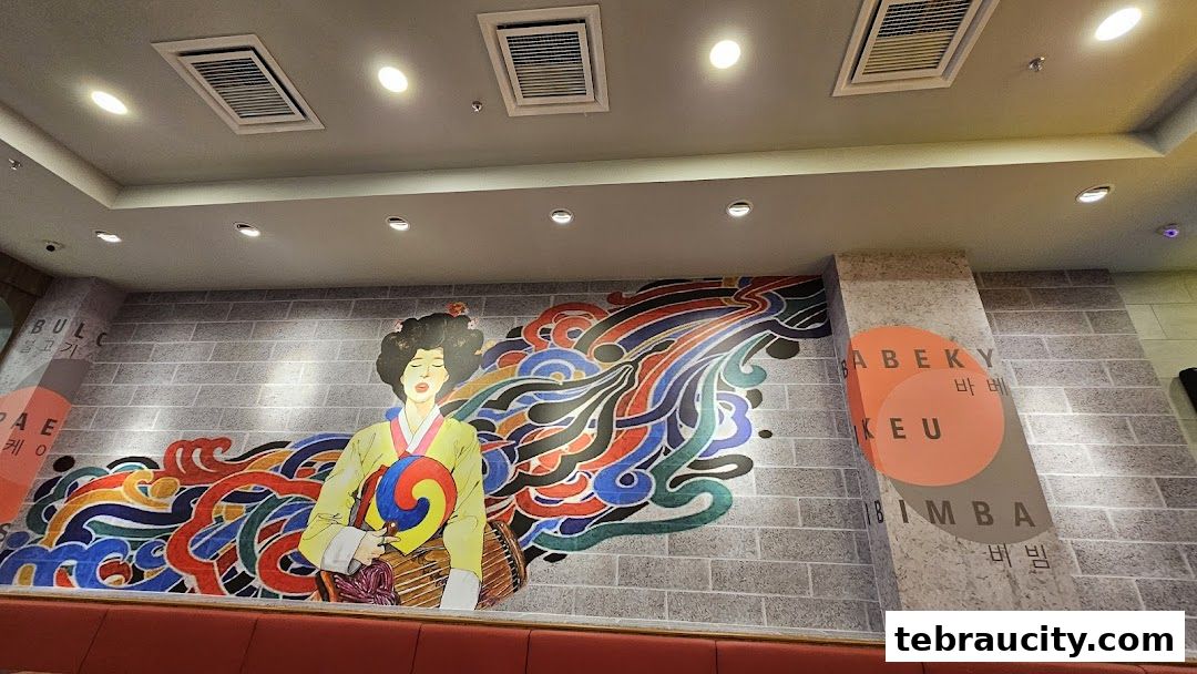 Interior wall art at Chego Korean BBQ featuring a traditional Korean woman and colorful abstract designs.