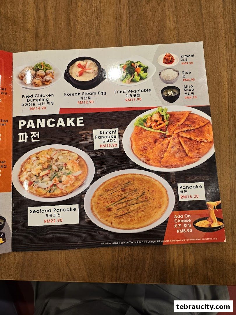 A menu featuring Korean dishes including various pancakes, fried chicken dumplings, and steam egg.