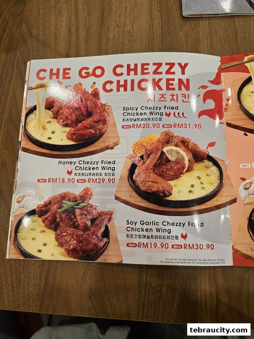A menu featuring Che Go Chezzy Fried Chicken Wings in three flavors: Spicy, Honey, and Soy Garlic.