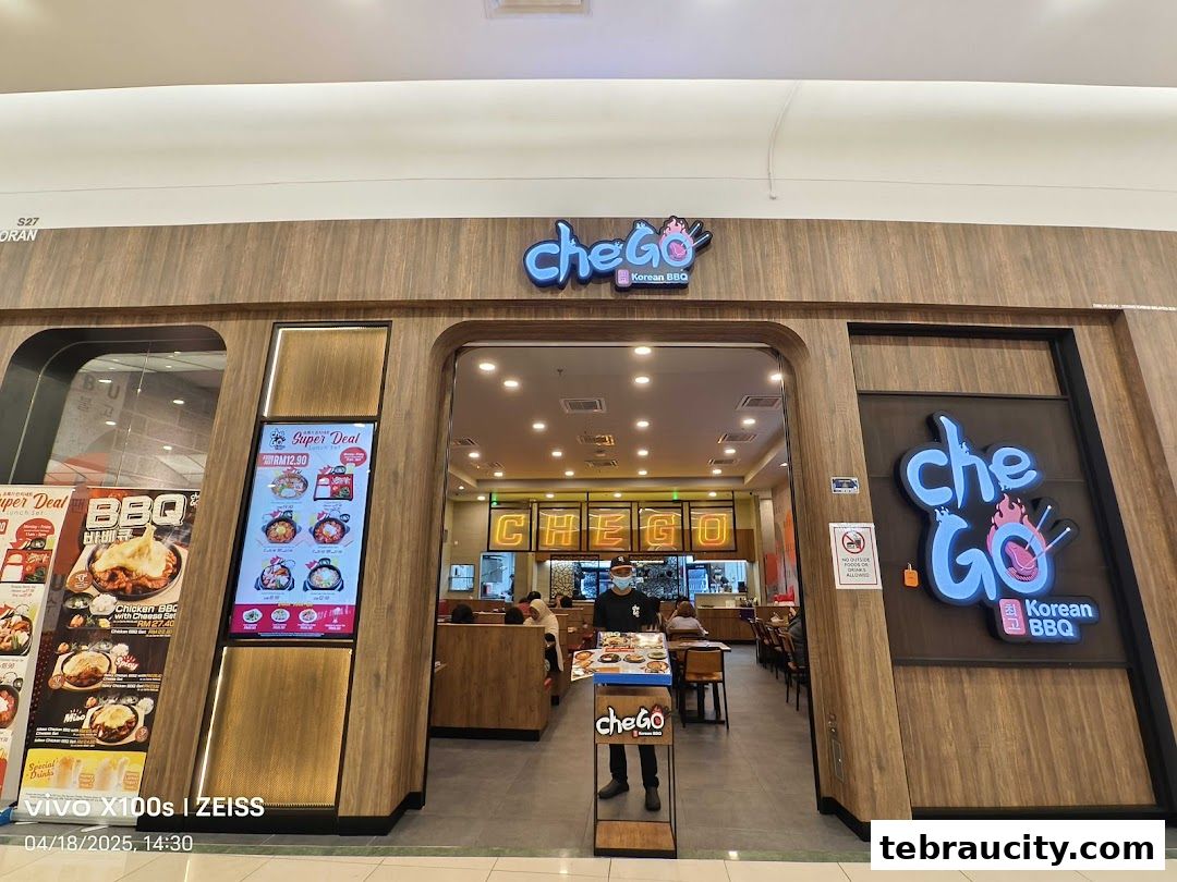 The exterior of Chego Korean BBQ restaurant with its prominent signage and menu displays.