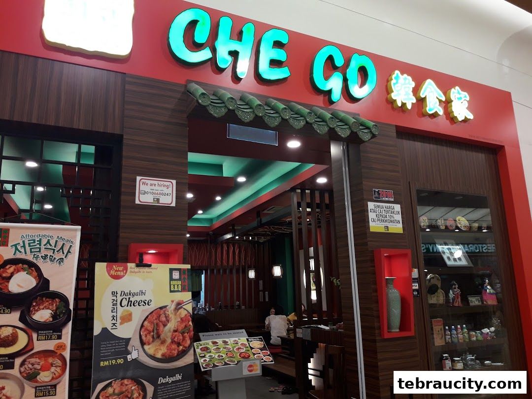 The exterior of Chego Korean BBQ restaurant with its prominent signage and menu displays.