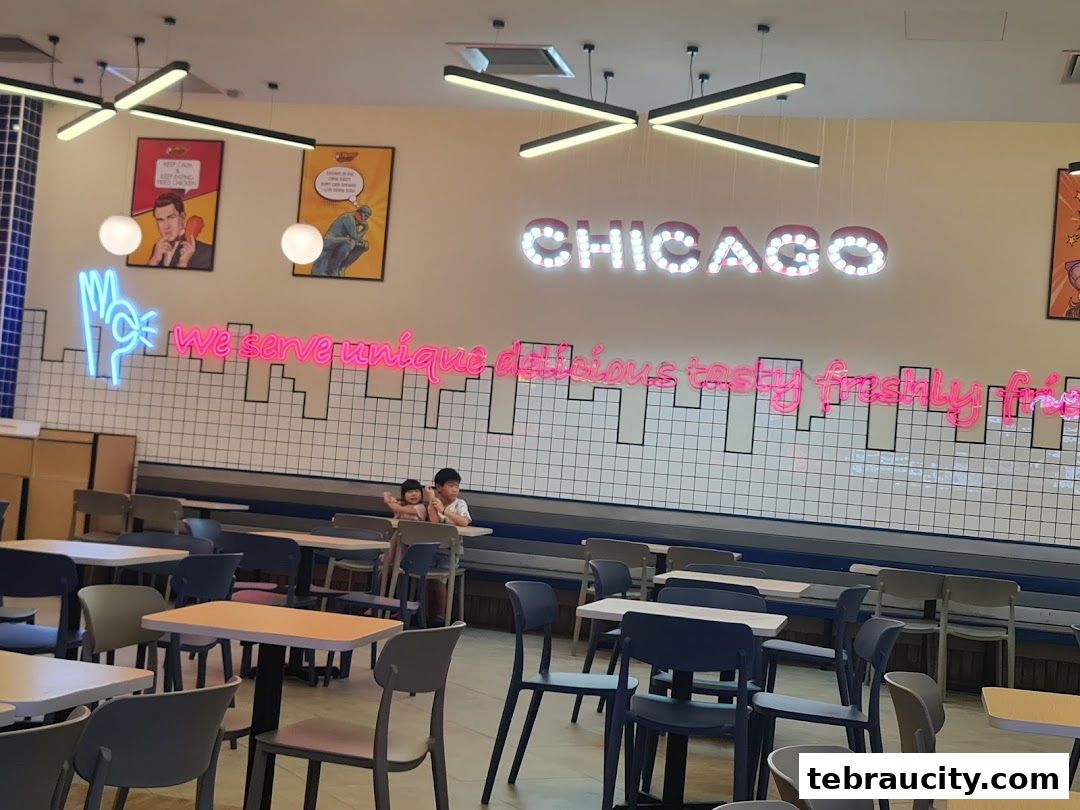 Interior of Chicago Chicken City with neon signs and seating.