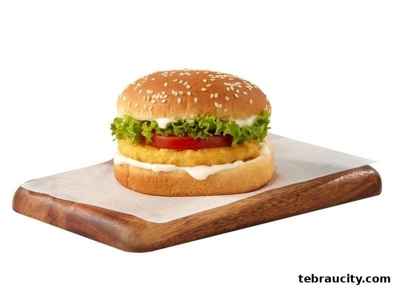 A delicious chicken burger with lettuce, tomato, and sauce on a sesame seed bun.