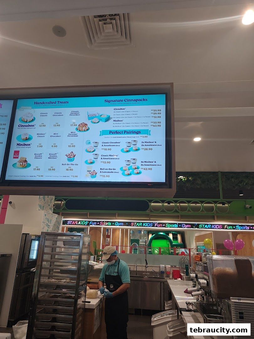 A Cinnabon menu displaying handcrafted treats and signature cinnapacks with prices.