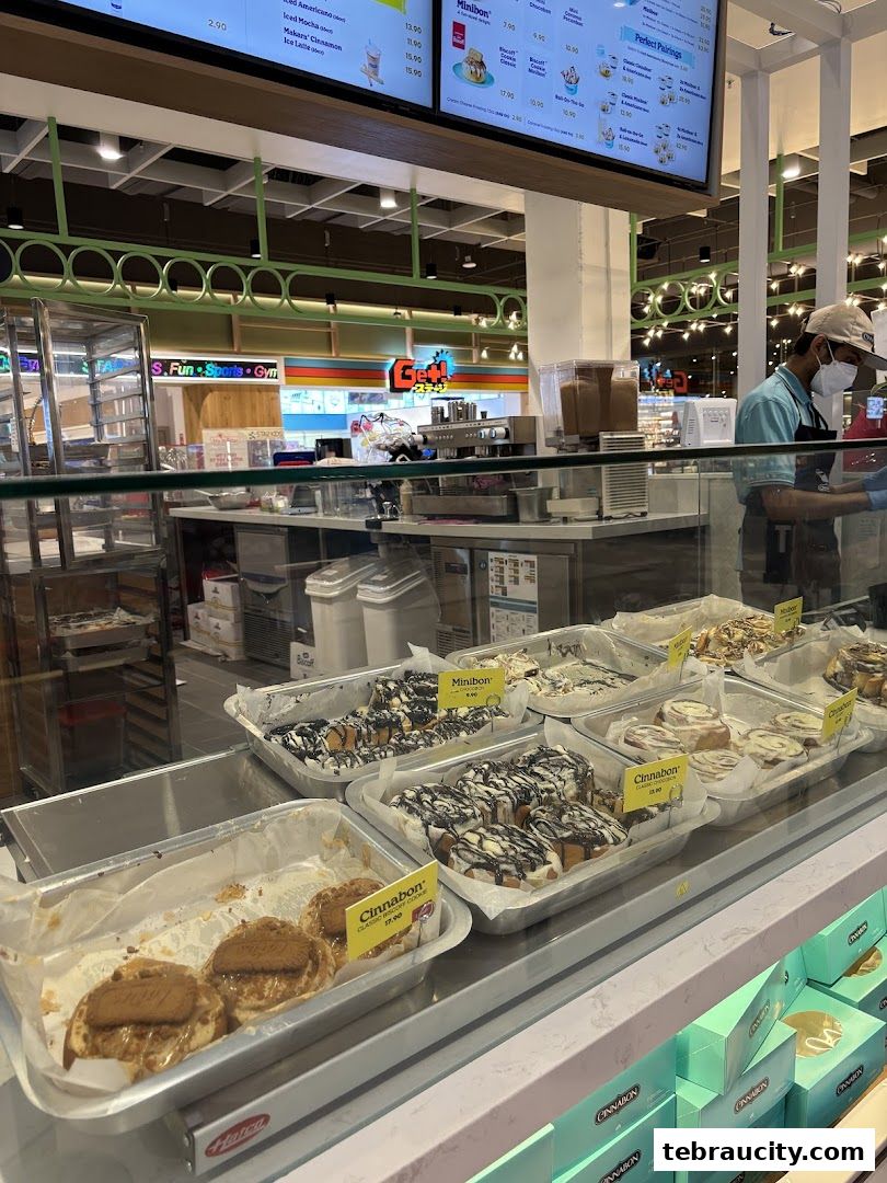 A display of freshly baked Cinnabon cinnamon rolls and other sweet treats.