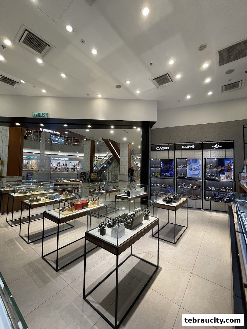 Interior view of a modern watch store with display cases filled with watches.