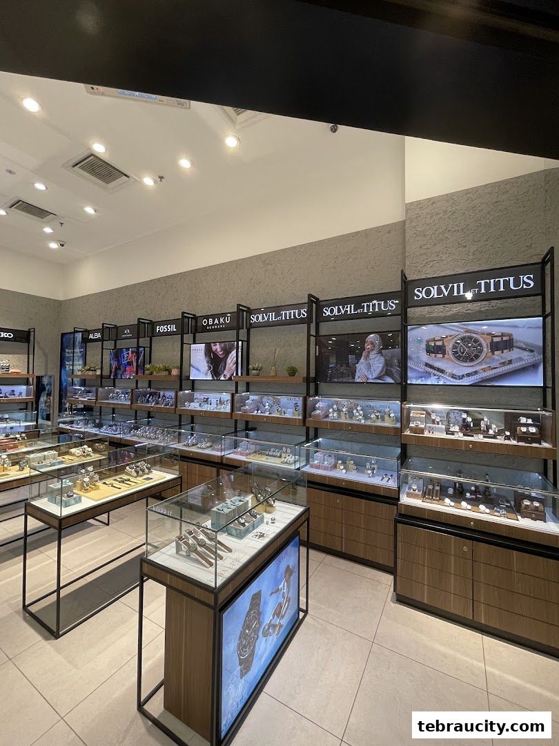 Interior view of a modern watch store showcasing various brands and styles in display cases.