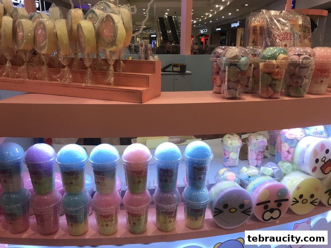 A display of colorful cotton candy and marshmallow treats in various packaging.