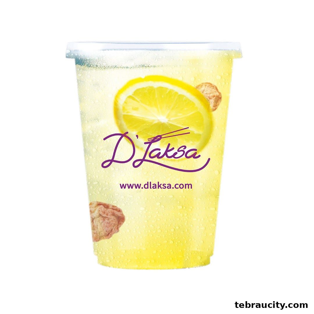 A refreshing D Laksa beverage with lemon and ice, featuring the brand logo and website.