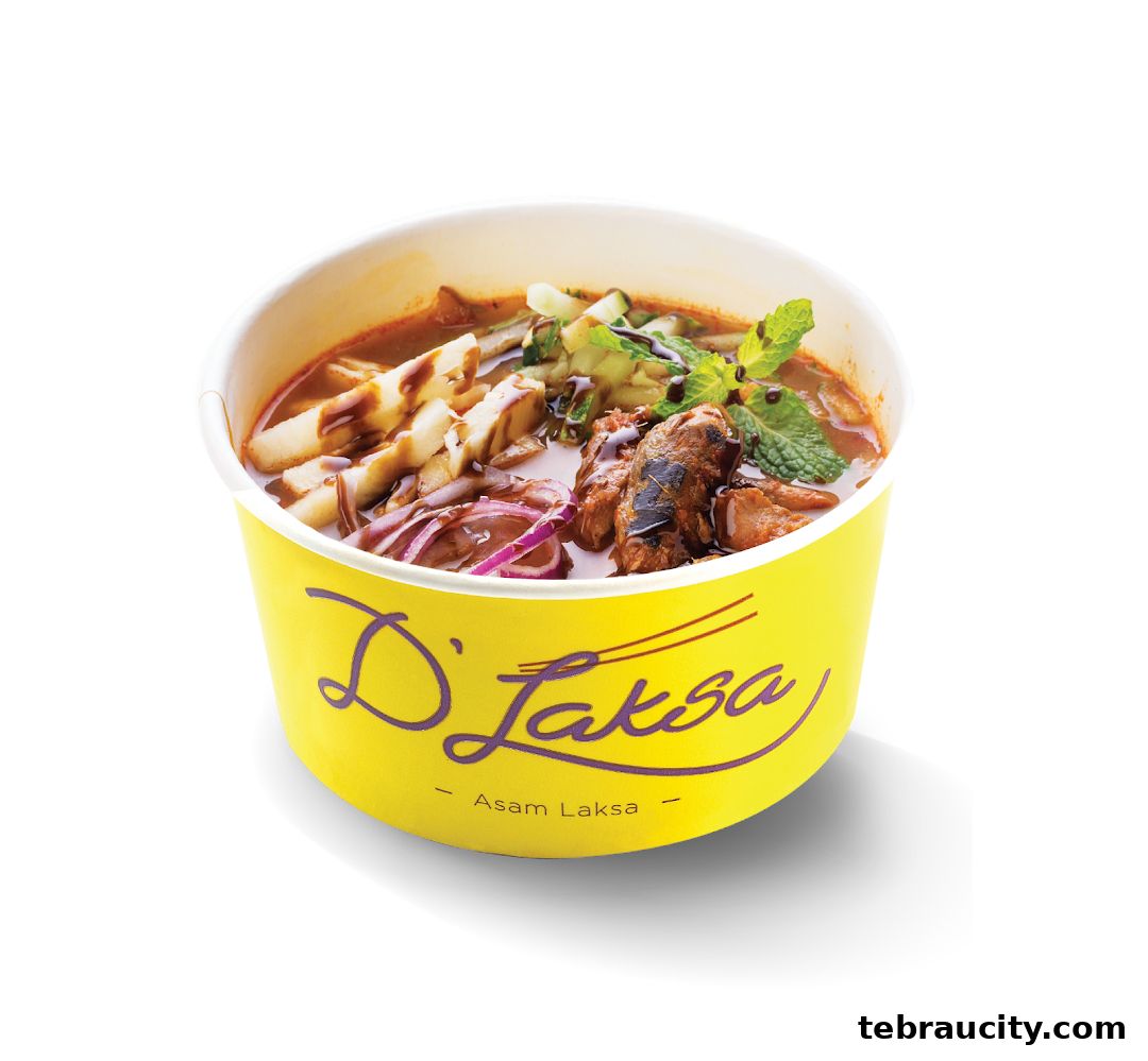 A bowl of Asam Laksa with meat, noodles, vegetables, and mint leaves.