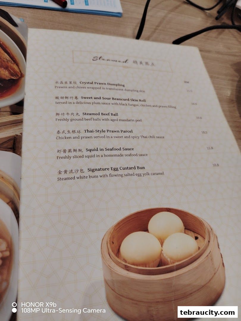 A menu from Dolly Dim Sum featuring steamed dim sum items with descriptions and prices.