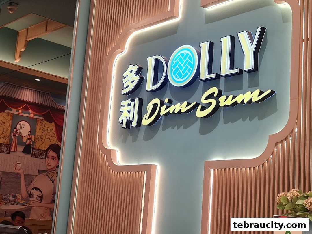 The illuminated sign for Dolly Dim Sum restaurant with a decorative mural on the side.