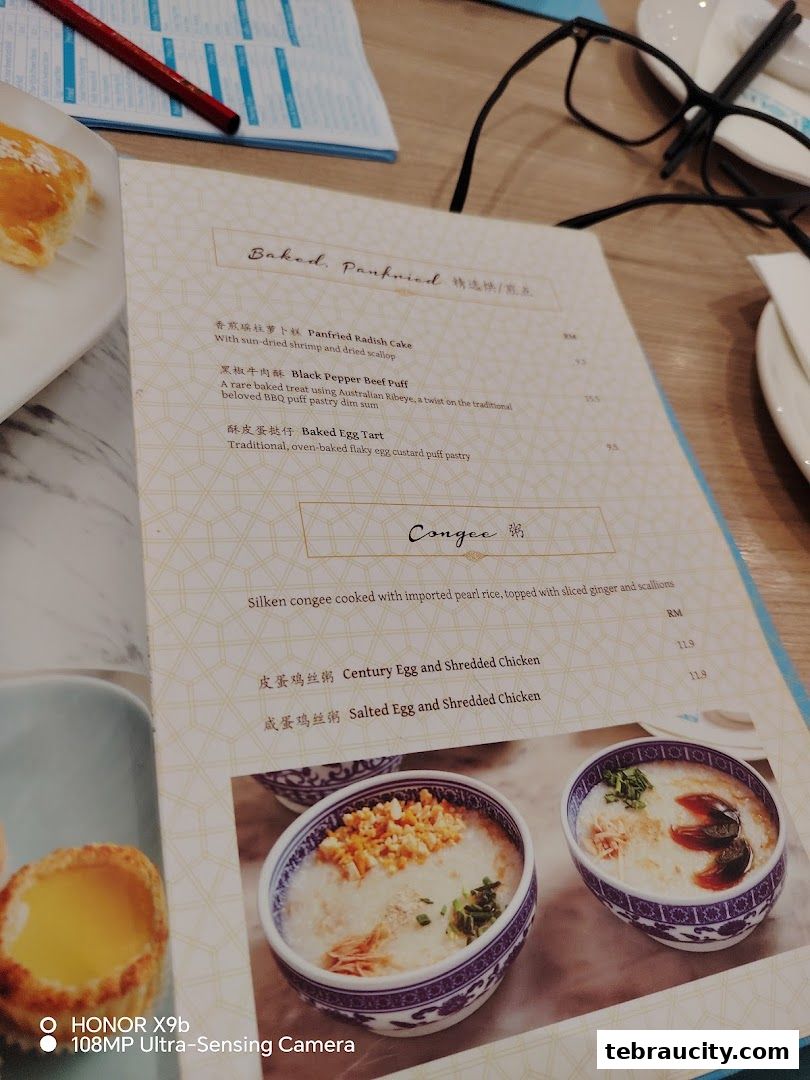 A menu from Dolly Dim Sum featuring baked, pan-fried dishes and congee.