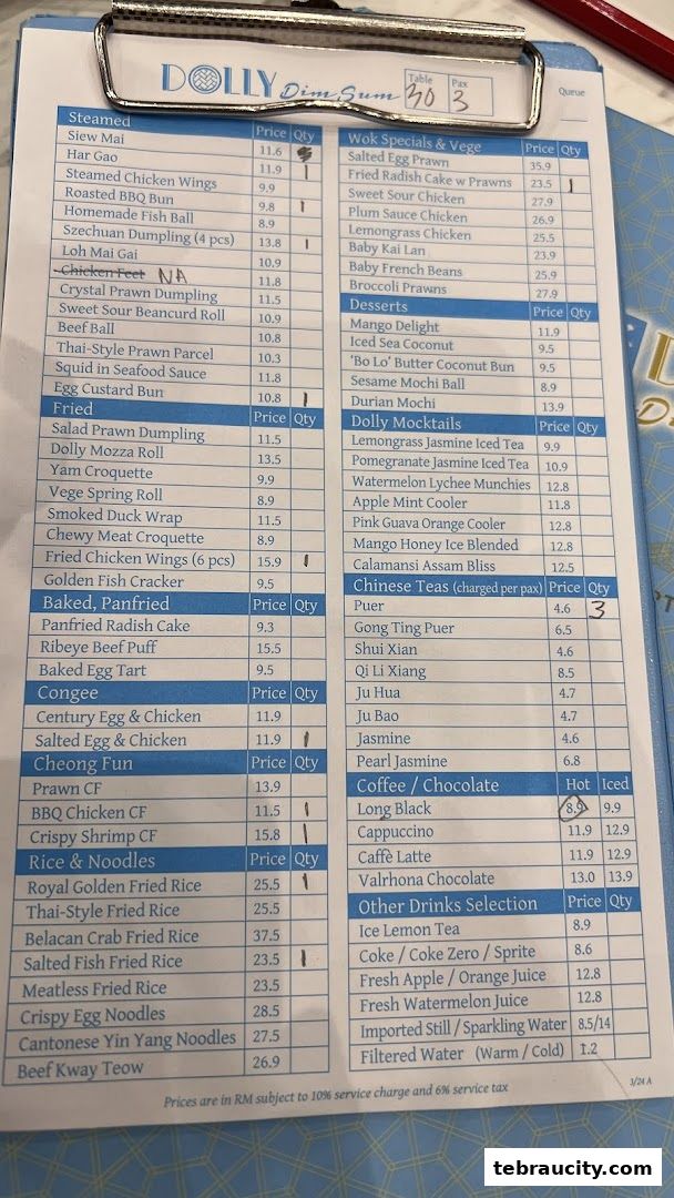 A close-up view of a Dolly Dim Sum menu with various dim sum and drink options listed.