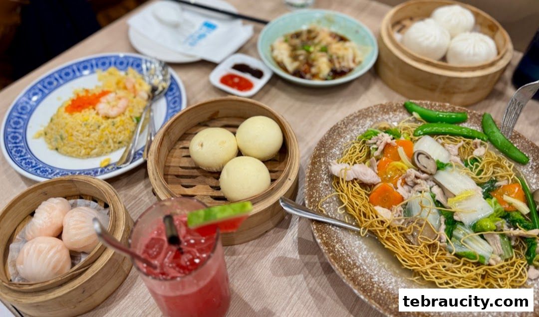 A table filled with various delicious dim sum dishes and a refreshing drink.