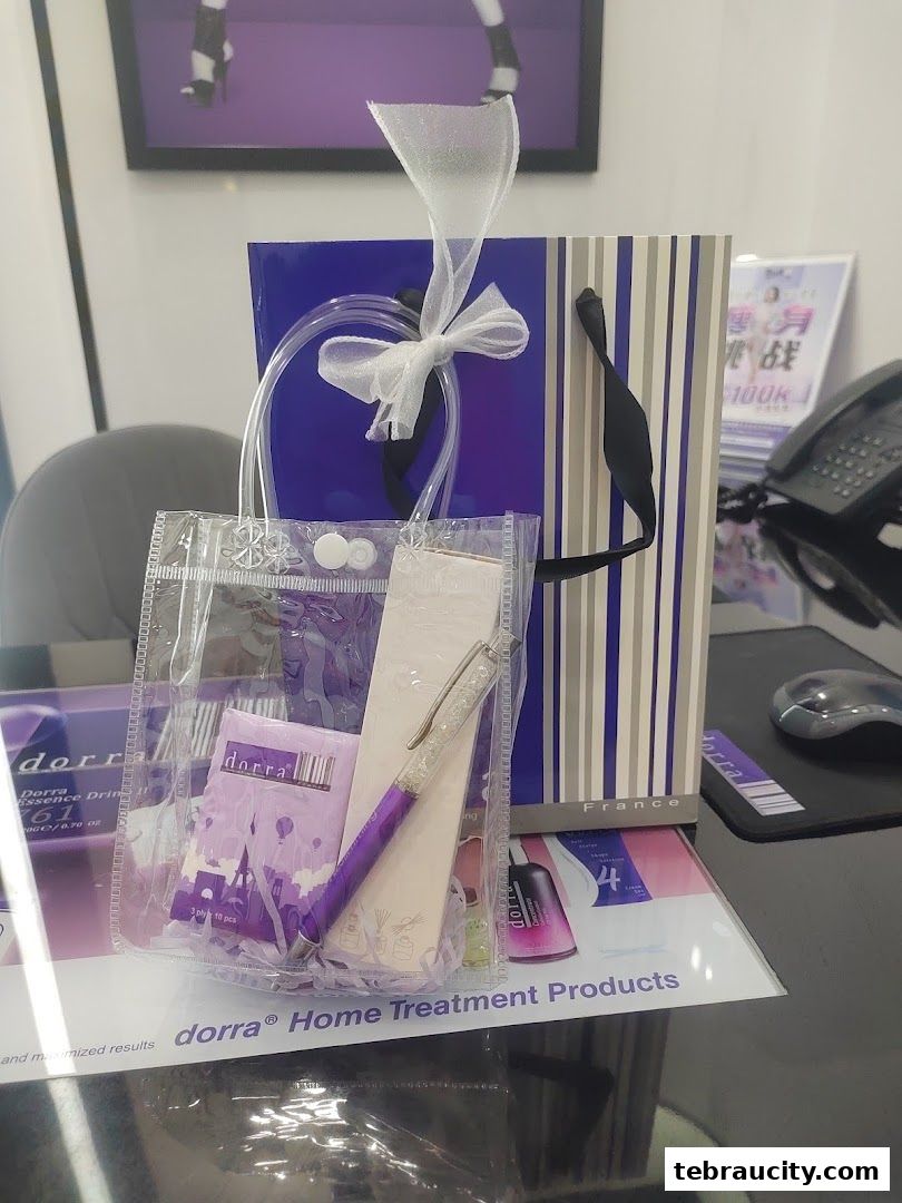 A gift bag with Dorra slimming products and a pen on a desk.